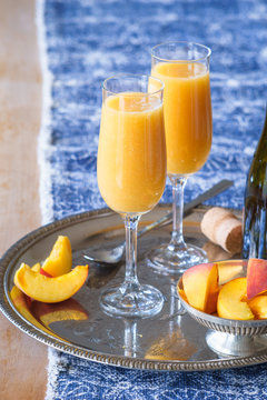 Two champagne flutes with Bellini cocktail. Selective focus