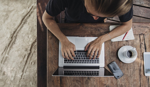 Man using laptop in cafe