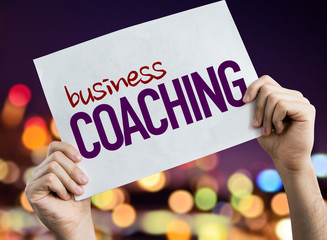 Business Coaching placard with night lights on background
