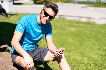 Sporty guy listening to music while training 