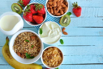 Colorful and tasty breakfast ingredients on blue table, top view
