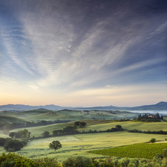 View to field and old villa in the morning  in Tuscany in Italy