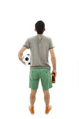 Young man holding ball and beer, looking at wall. Rear view. Isolated on white background