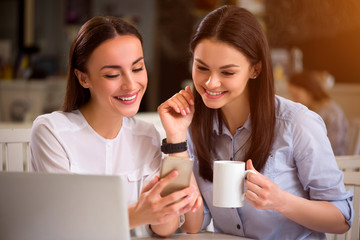Positive pleasant friends sitting in the cafe