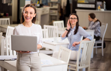 Nice smiling  woman holding laptop 