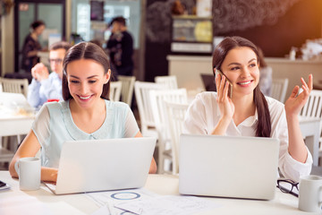 Positive colleagues sitting at the table  
