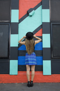 Asian woman admiring painted wall