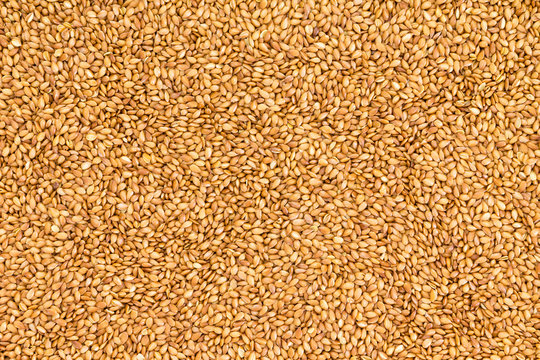 Background texture of roasted golden flax seed