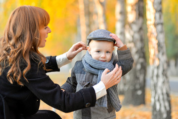 Mother with baby in the park in autumn.