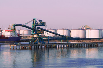 Crane and Oil bunkers at Marina in Ventspils at sunset