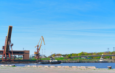 Fototapeta na wymiar Ships and lifting cranes at Marina in Ventspils