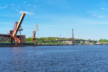 Obraz premium Ships and lifting cranes at the Marina in Ventspils