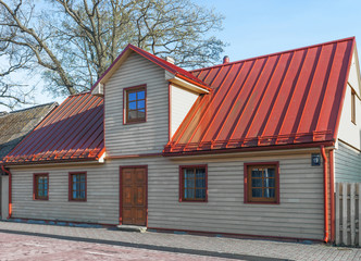Fototapeta na wymiar Building with a red roof in Ventspils in Latvia