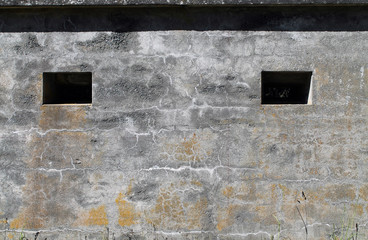 Two Windows in the Cement Wall of a Military Bunker