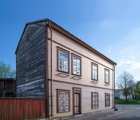 Old wooden house and a fence in Ventspils of Latvia