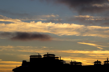 Fototapeta na wymiar Beautiful sunset over roofs of houses