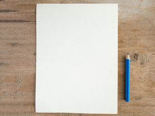 Blank paper with pencil on wood table