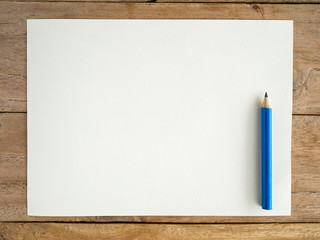 Blank paper with pencil on wood table