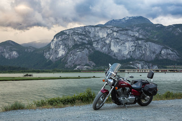 Cruser motorcycle on a dirt road with a moutainous background (Chief Mountain). Taken in Squamish, BC, Canada