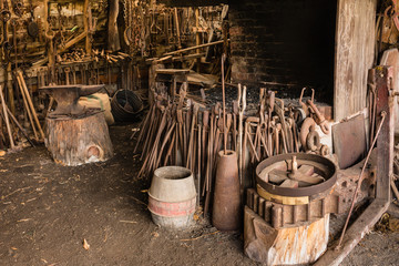 old blacksmith workshop with tools and furnace - obrazy, fototapety, plakaty