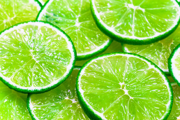 Green background with citrus-fruit of lime slices