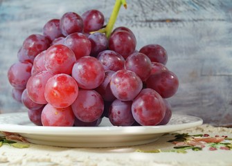 fresh red grape on a white plate - fruit diet
