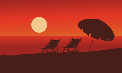 Naklejka premium Silhouette of summer beach at sunset