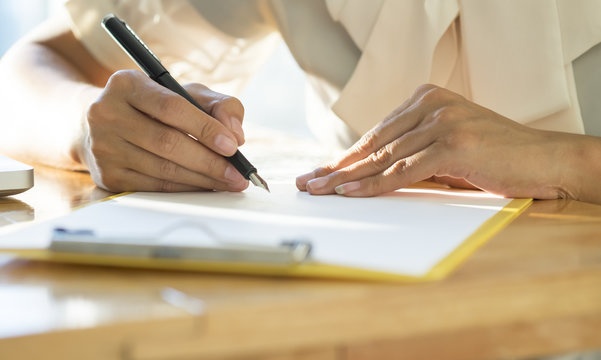 Asian Business woman signing a contract document 
