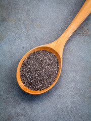 Nutritious chia seeds in wooden spoon for diet food ingredients.