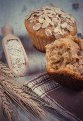 Vintage photo, Fresh muffins with oatmeal, rye flour and ears of rye grain, delicious healthy dessert