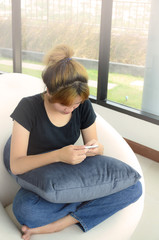 Asian girl pay attention to her smatrphone.