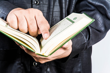 Koran in hand - holy book of Muslims ( public item of all muslims )