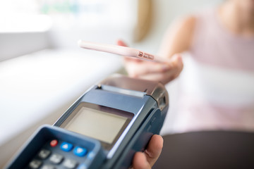 Woman using mobile phone to pay