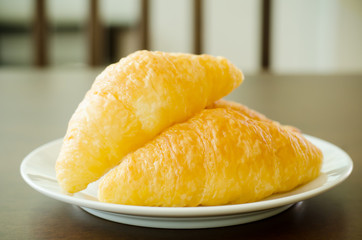 Croissant on white plate,breakfast,meal