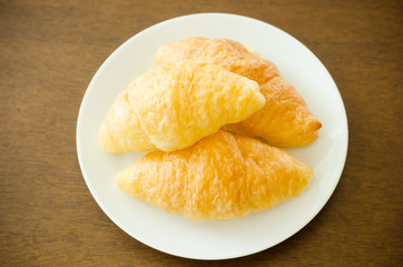 Croissant on white plate,breakfast,meal