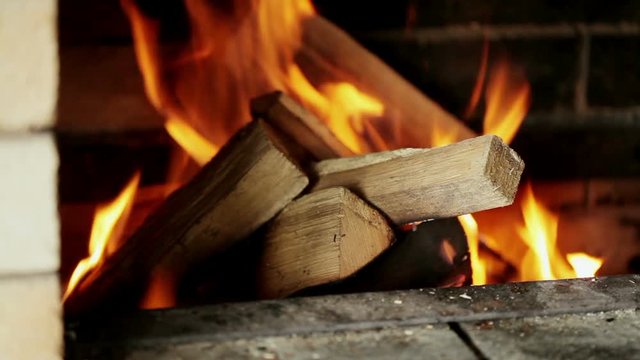 Rural life. Burning chop wood in the stone fire-place from fire-bricks.