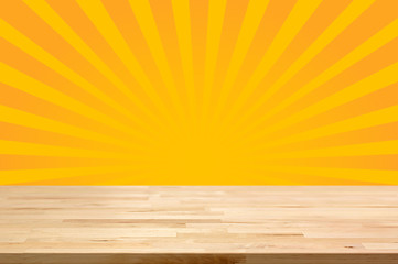 Wood table top on yellow sunburst (or radiating) background