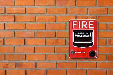 Fire alarm switch on brick wall texture background