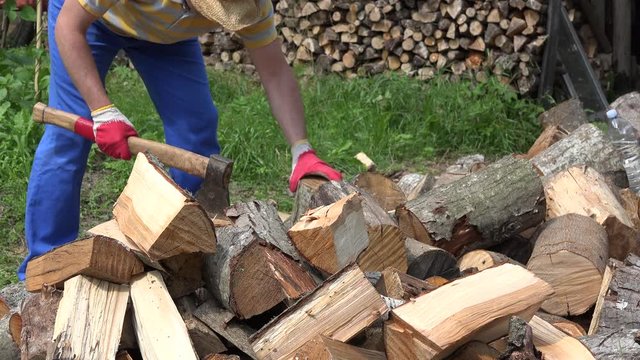Farmer man chop wood in backyard. 4K
