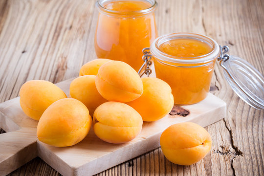 Fresh apricots and homemade apricot chutney  in a glass jar