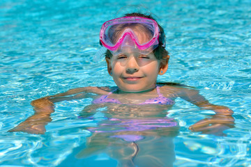 Adorable toddler girl enjoying her summer vacation at beach