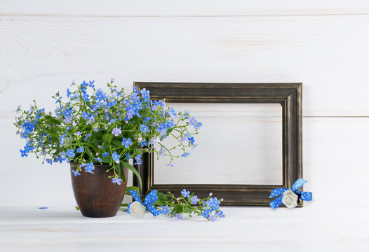 Forget-me-not flowers bouquet and photo frame