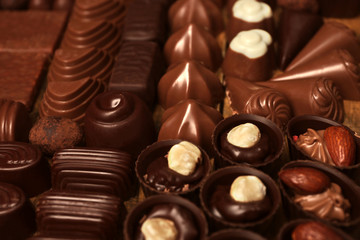 Assortment of delicious chocolate candies background, close up