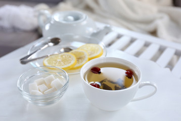 Tea set on a white wooden tray