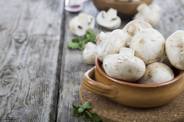 Raw mushrooms in a bowl on a table