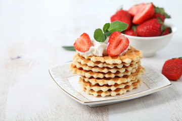 Delicious waffles with strawberries and mint