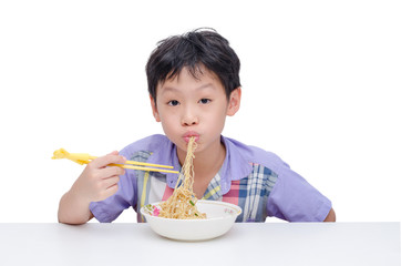 Young asian boy eating noodle by chob stick