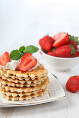 Delicious waffles with strawberries and mint