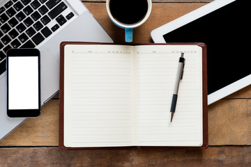 Office workspace with blank screen notebook, pen, blank screen tablet, cup of cofee, blank screen smartphone and labtop.Flat lay photo.Top view with copy space