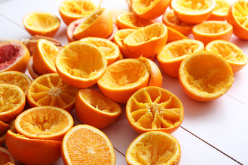 Juicing delicious citruses on white wooden background